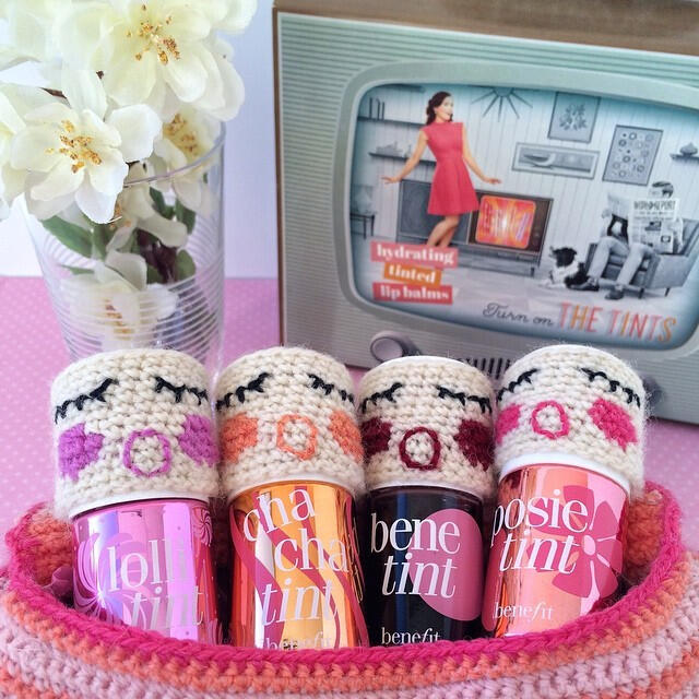 Benefit Tints sit in a crocheted basket with crocheted benebabies faces matching the tint colours